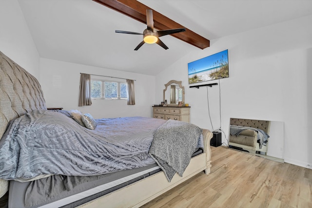 bedroom featuring ceiling fan, vaulted ceiling with beams, and light wood-type flooring