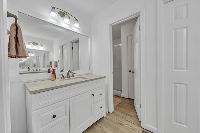 bathroom featuring vanity and hardwood / wood-style flooring