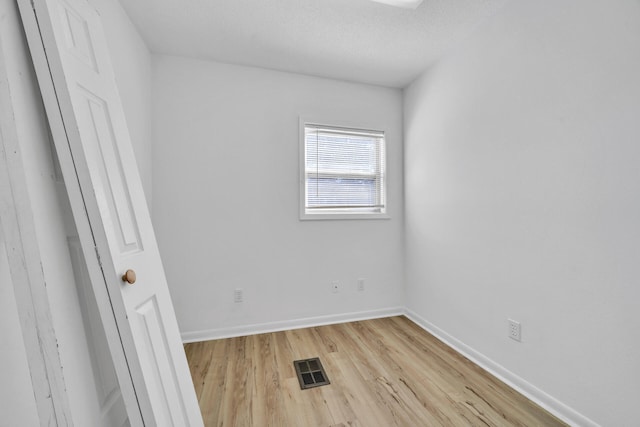 spare room with light hardwood / wood-style flooring