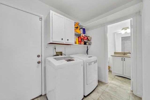 clothes washing area featuring light tile floors, cabinets, sink, independent washer and dryer, and washer hookup