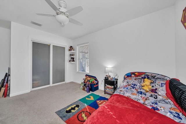 bedroom with ceiling fan and light carpet