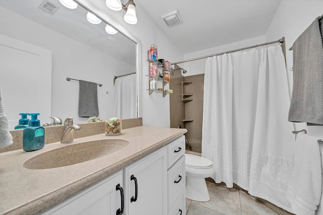 bathroom with large vanity, tile floors, and toilet