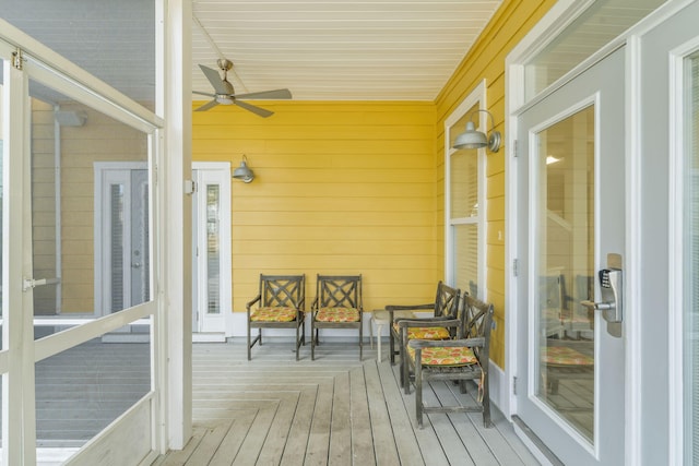 sunroom / solarium featuring ceiling fan