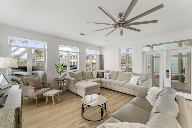 living room with ornamental molding, a healthy amount of sunlight, light hardwood / wood-style floors, and ceiling fan