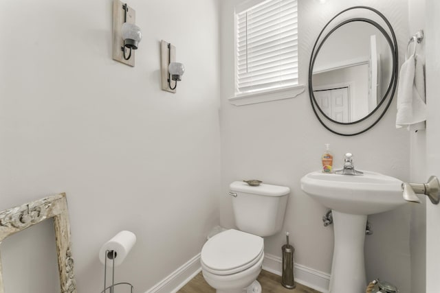 bathroom with hardwood / wood-style floors and toilet