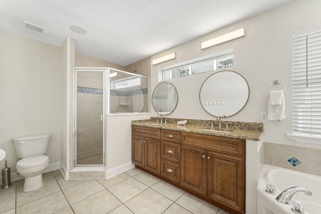 full bathroom with tile floors, separate shower and tub, large vanity, double sink, and toilet