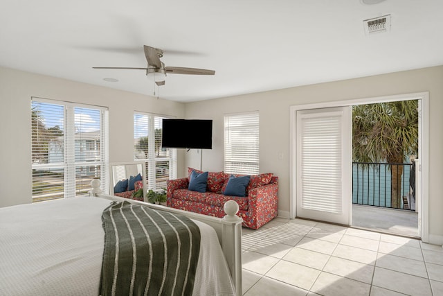 tiled bedroom featuring ceiling fan and access to exterior