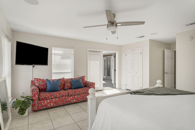 tiled bedroom featuring a closet and ceiling fan