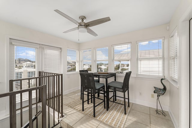 tiled dining space featuring ceiling fan