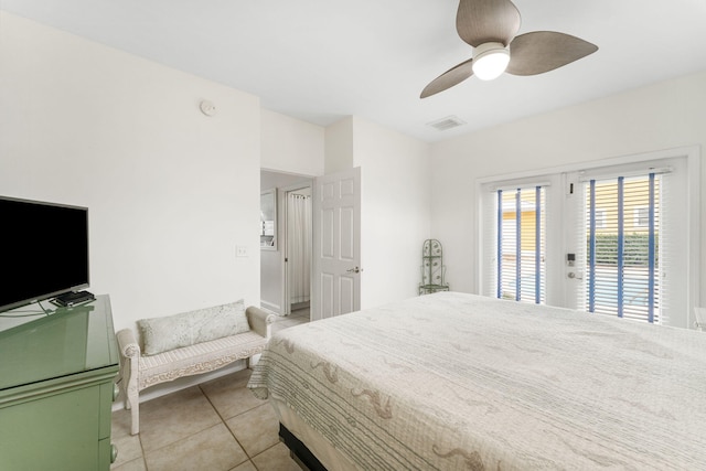 tiled bedroom with ceiling fan and access to outside