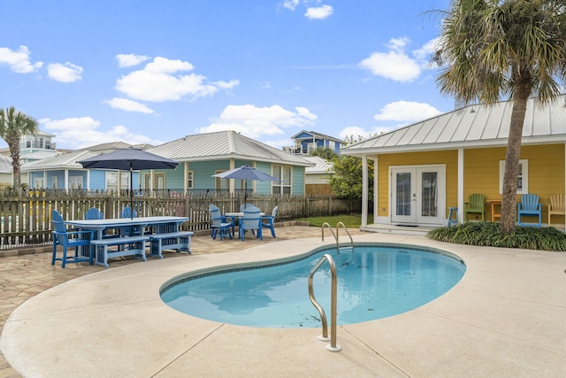 view of swimming pool with a patio and french doors