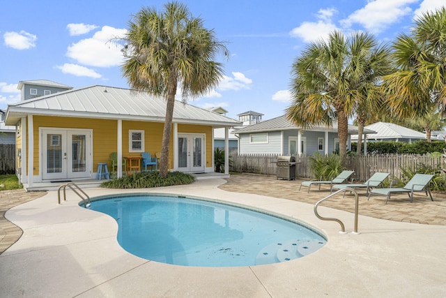 view of pool with a patio area, grilling area, and french doors