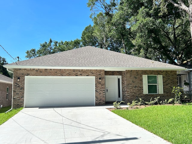 ranch-style house featuring a garage and a front lawn