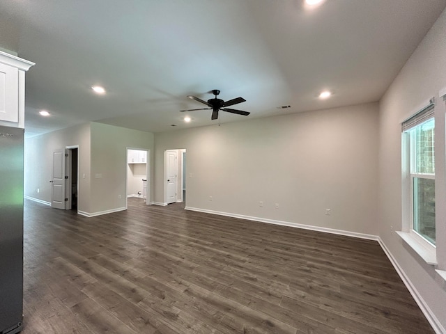 unfurnished living room with dark hardwood / wood-style flooring and ceiling fan