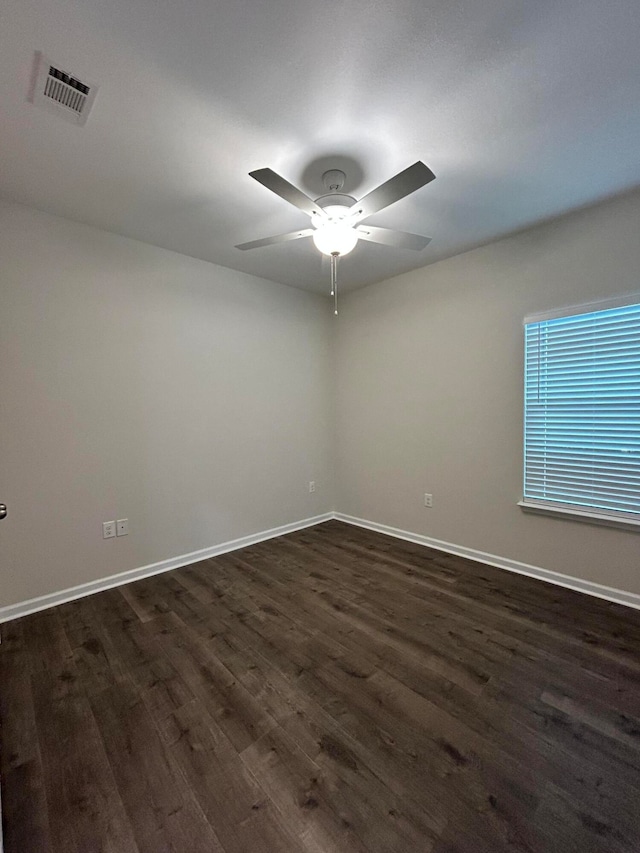 unfurnished room featuring dark hardwood / wood-style floors and ceiling fan