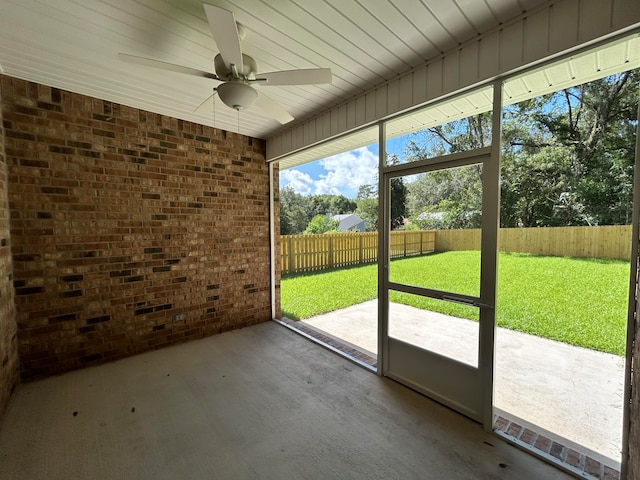 unfurnished sunroom featuring ceiling fan