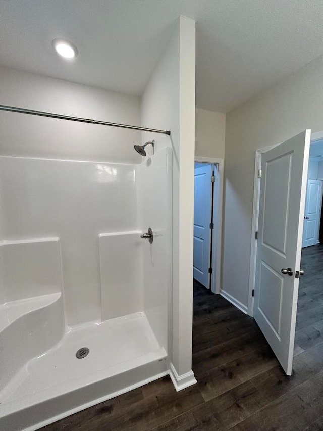 bathroom featuring hardwood / wood-style flooring and a shower