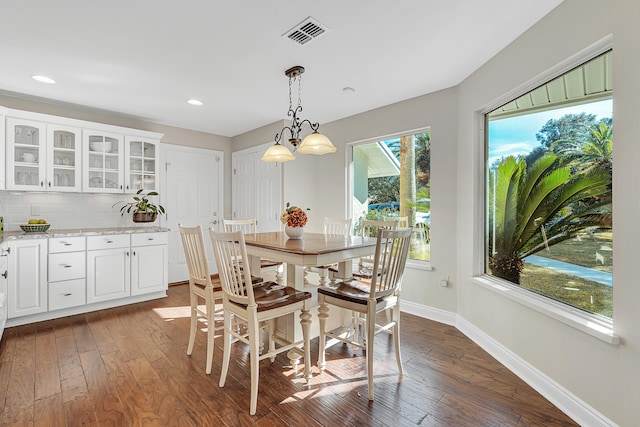 dining space with dark wood-type flooring