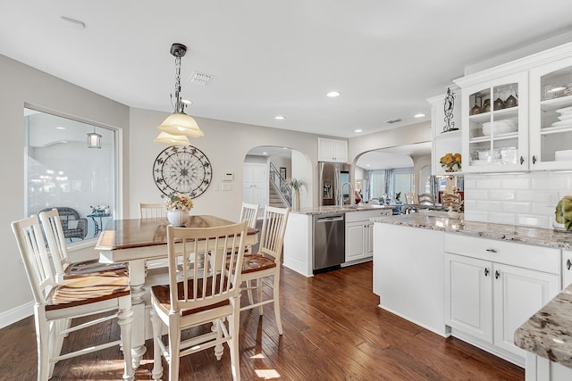 dining space with dark hardwood / wood-style flooring and sink