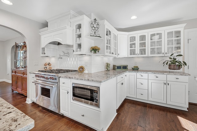 kitchen featuring stainless steel appliances, light stone countertops, dark hardwood / wood-style floors, and white cabinets