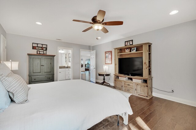 bedroom with ensuite bathroom, dark hardwood / wood-style floors, and ceiling fan