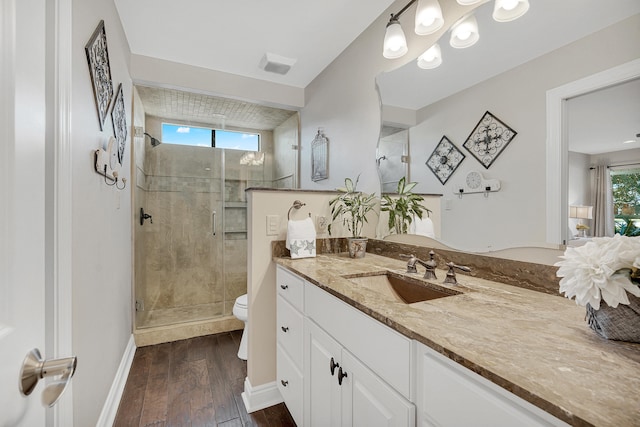 bathroom with vanity, hardwood / wood-style flooring, toilet, and walk in shower