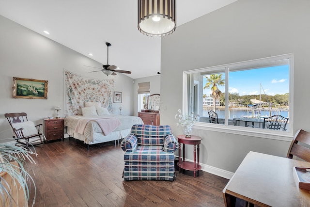 bedroom featuring dark wood-type flooring, high vaulted ceiling, and a water view