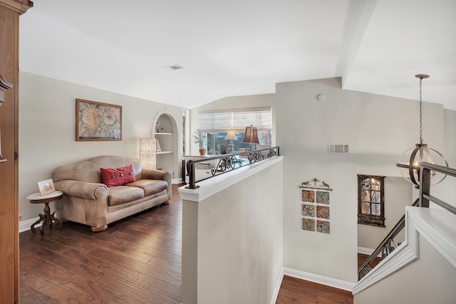 hall featuring built in shelves, lofted ceiling, and dark hardwood / wood-style floors