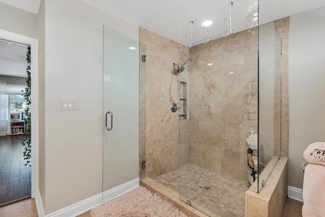 bathroom with a shower with door