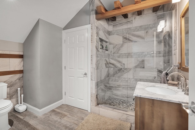 bathroom with lofted ceiling, hardwood / wood-style flooring, vanity, toilet, and a shower with door