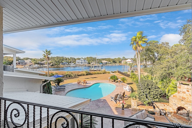 view of swimming pool featuring a water view and a patio area