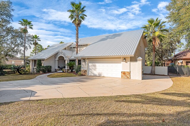 view of front of home featuring a garage and a front lawn