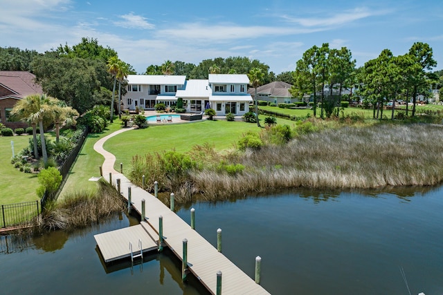 dock area with a yard and a water view