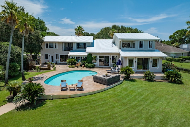 back of house with a yard, a patio, and a balcony