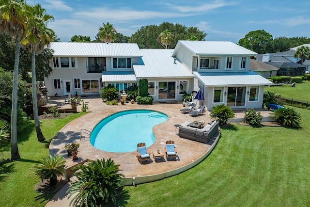 back of property featuring an outdoor living space, a balcony, a yard, and a patio area