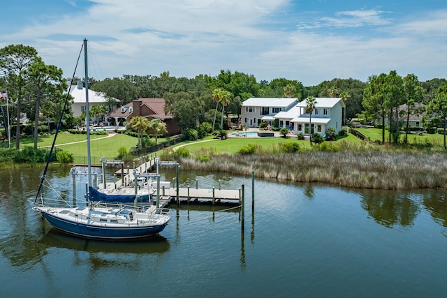 view of dock with a water view and a yard