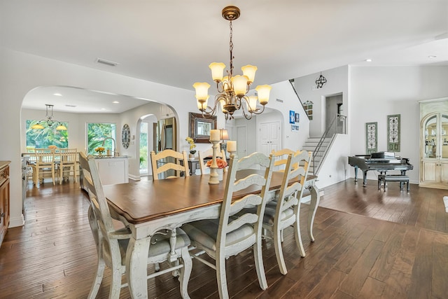 dining room featuring an inviting chandelier and dark wood-type flooring