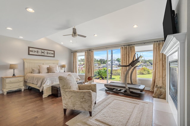 bedroom with ceiling fan, lofted ceiling, and dark hardwood / wood-style floors