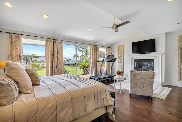 bedroom with lofted ceiling, a premium fireplace, ceiling fan, access to exterior, and dark hardwood / wood-style floors