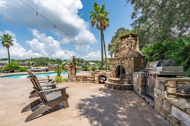 view of patio featuring a community pool and exterior kitchen