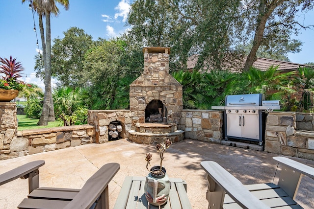 view of patio / terrace featuring area for grilling and an outdoor stone fireplace