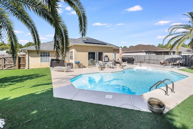 view of pool featuring a lawn and a patio