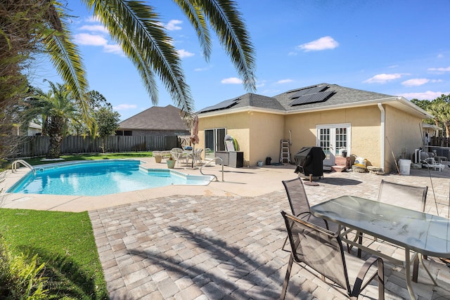 view of pool featuring french doors, area for grilling, and a patio