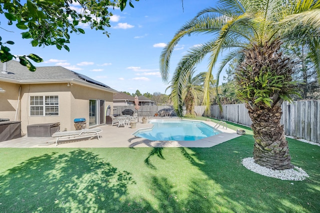 view of swimming pool with a yard, a jacuzzi, and a patio area