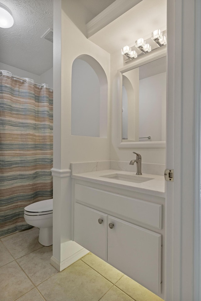 bathroom featuring tile patterned flooring, vanity, a textured ceiling, a shower with curtain, and toilet