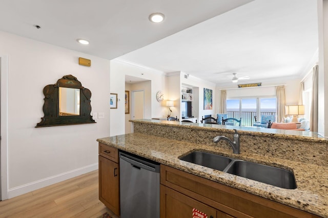 kitchen featuring ceiling fan, light stone countertops, light wood-type flooring, and stainless steel dishwasher