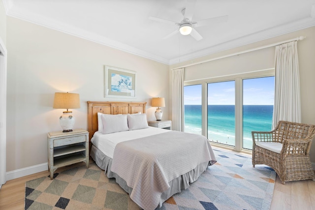 bedroom with ornamental molding, light hardwood / wood-style floors, ceiling fan, and access to exterior