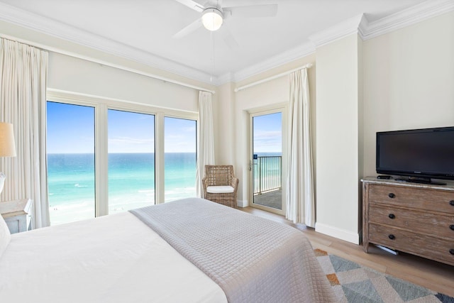 bedroom with a water view, ceiling fan, access to outside, hardwood / wood-style flooring, and ornamental molding