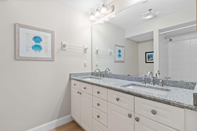 bathroom featuring wood-type flooring and double sink vanity