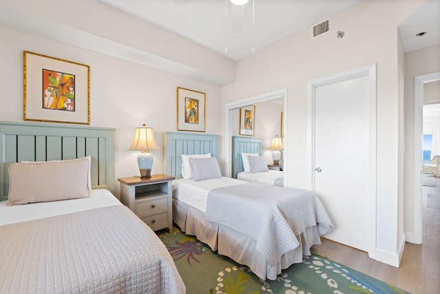 bedroom with light hardwood / wood-style floors and ceiling fan